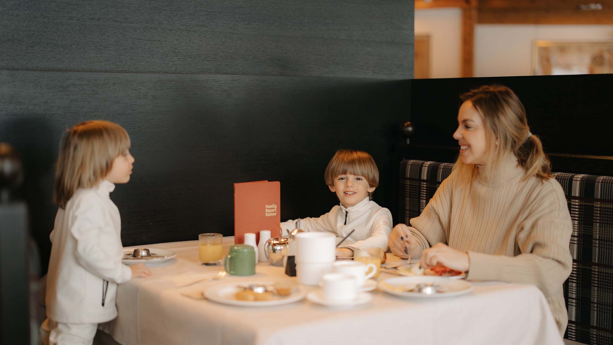 Gourmet delights from morning to night Woman and two children having breakfast in a restaurant