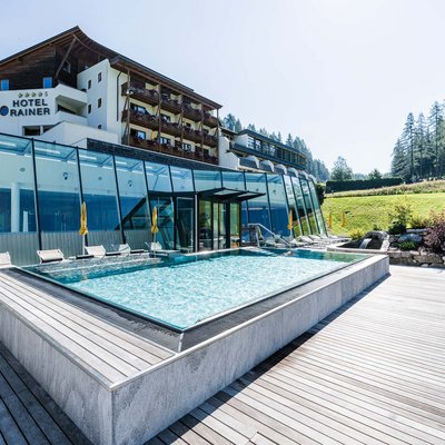 Hotel Rainer con piscina all'aperto e sdraio nel paesaggio montano