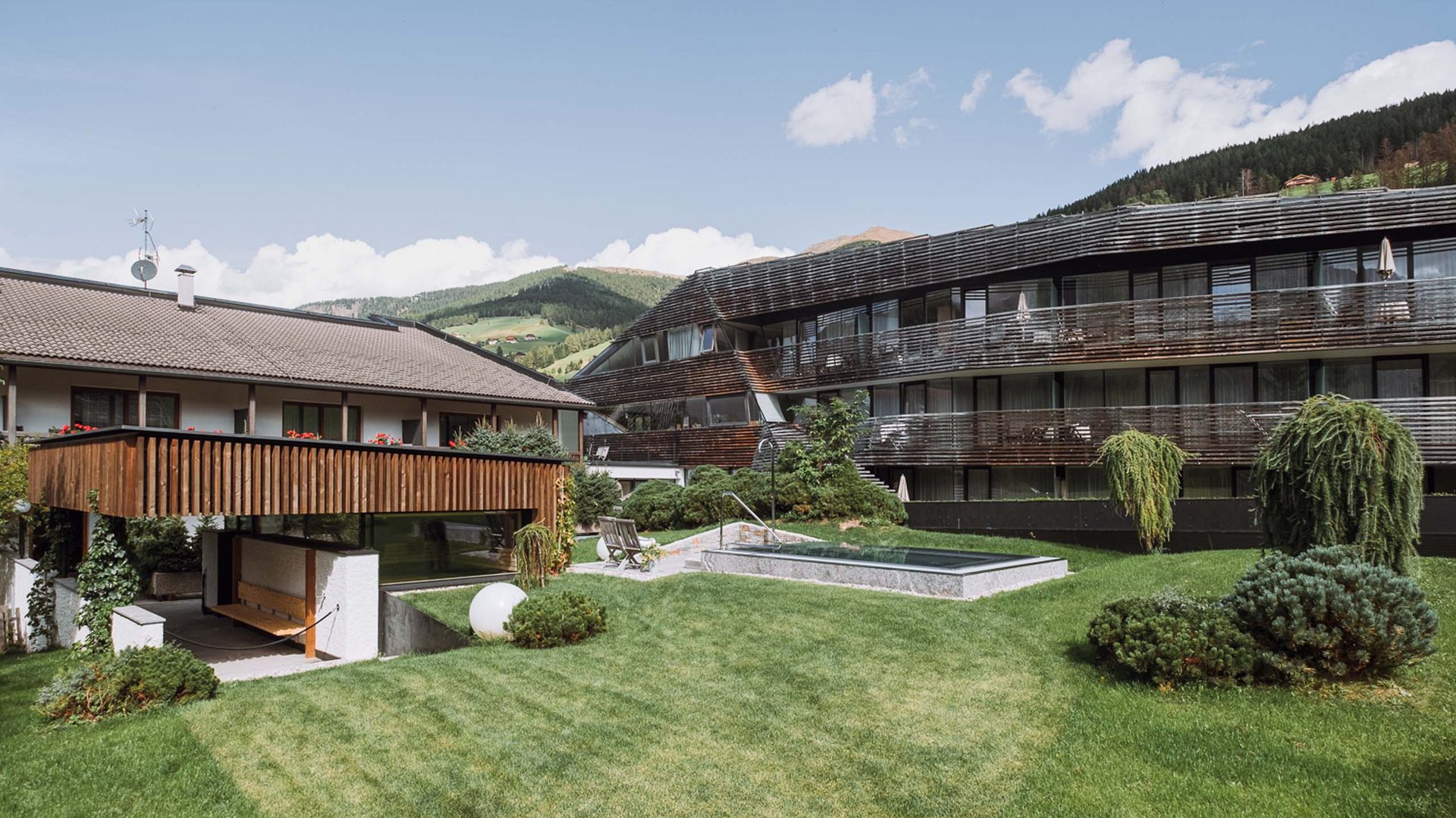 The Residence Königswarte Strata Modern buildings with garden and mountains in background on a sunny day