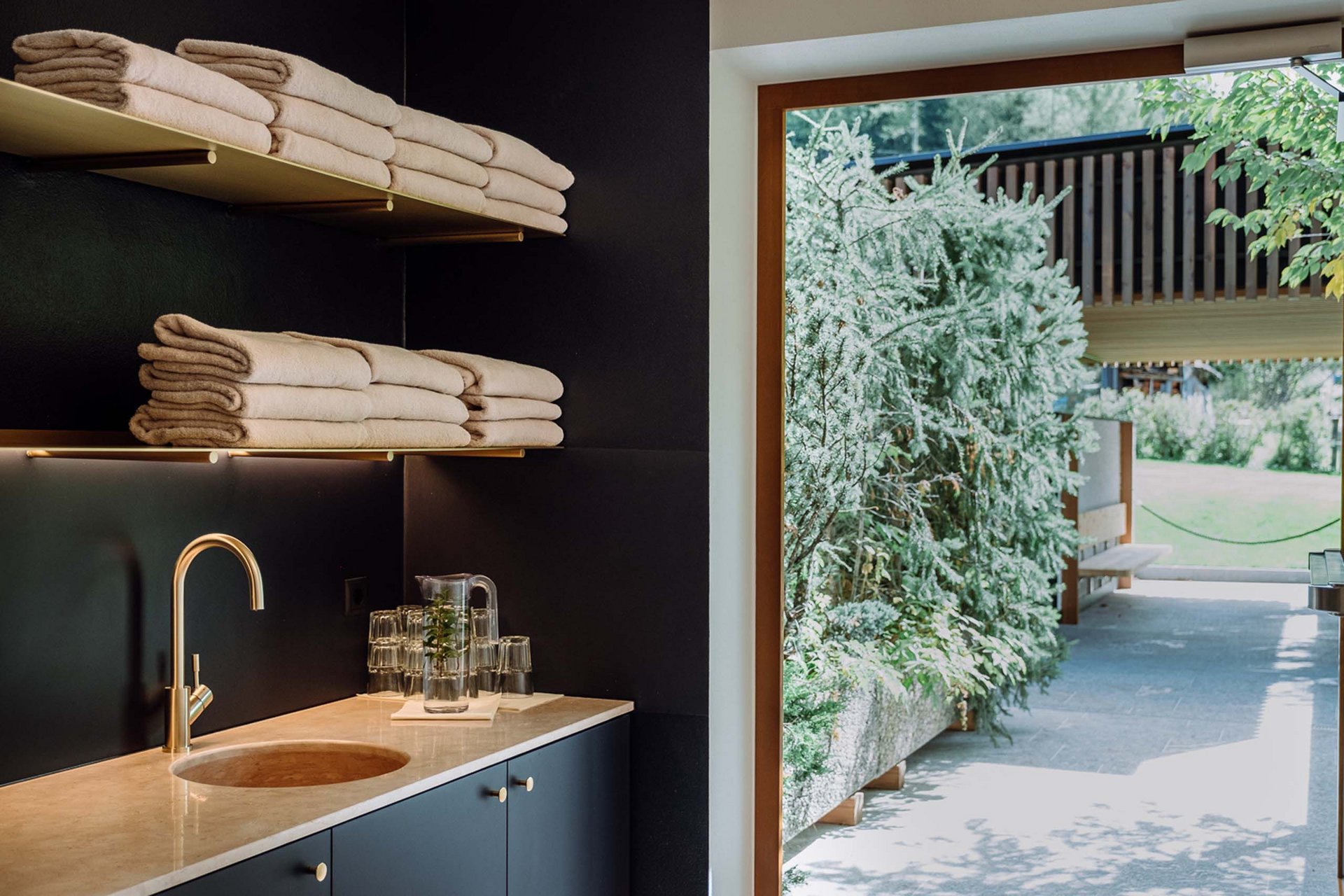The Residence Königswarte Strata Modern washroom with gold faucet and view of garden