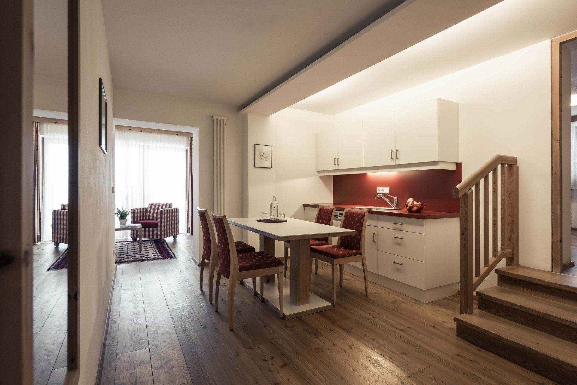 How to get to the Family Resort Rainer Modern kitchen and dining area with wooden floor and staircase