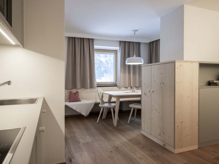 Naturerlebnis in der Villa Rainer Kleine moderne Küchen- und Essecke mit Holzmöbeln und Fenster