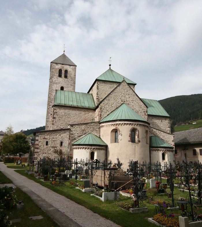 Sights around Sexten Historic church with green roof and adjacent cemetery