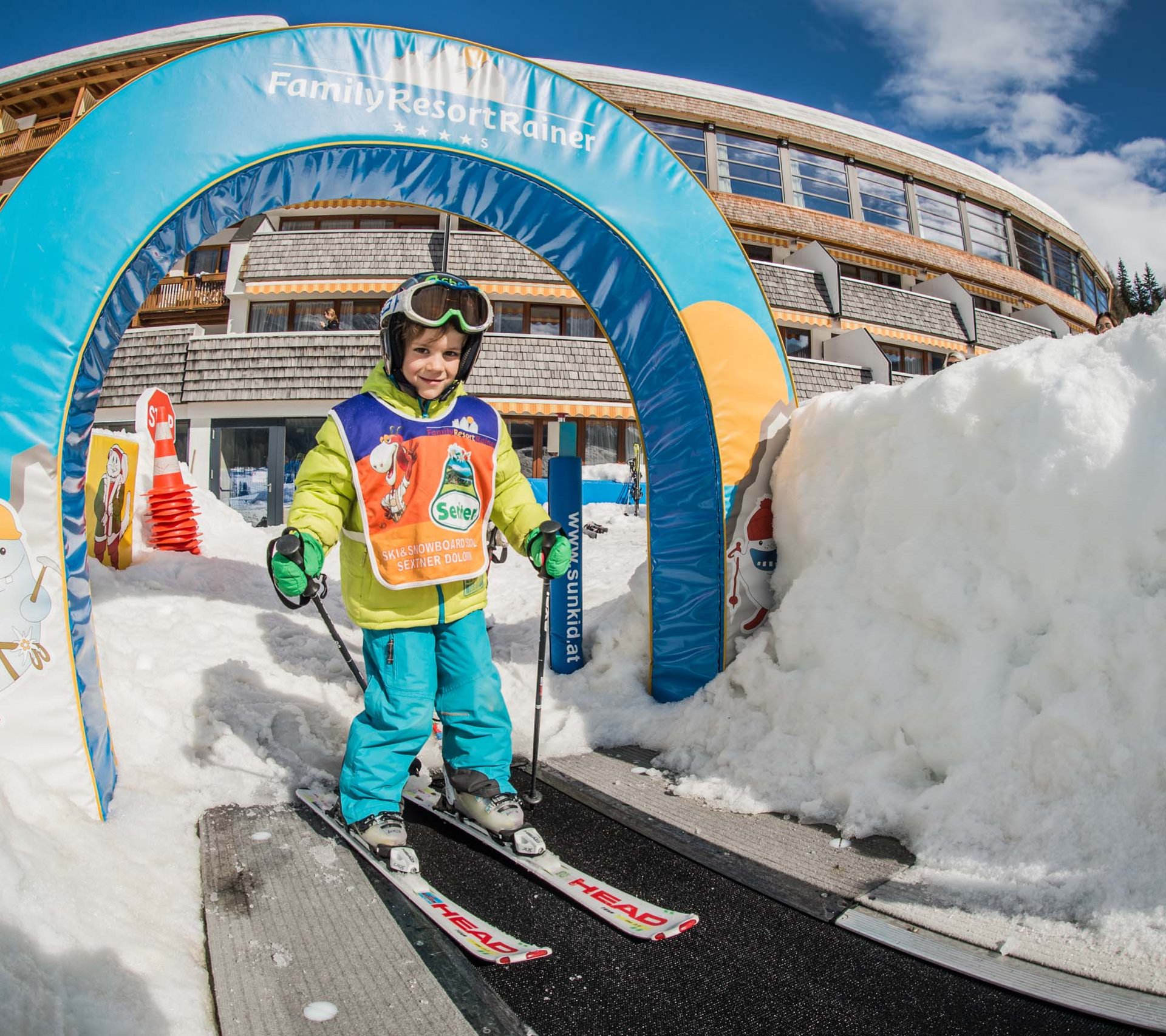 Property detail page - Hotel Rainer Child learning to ski on conveyor belt at Family Resort Rainer