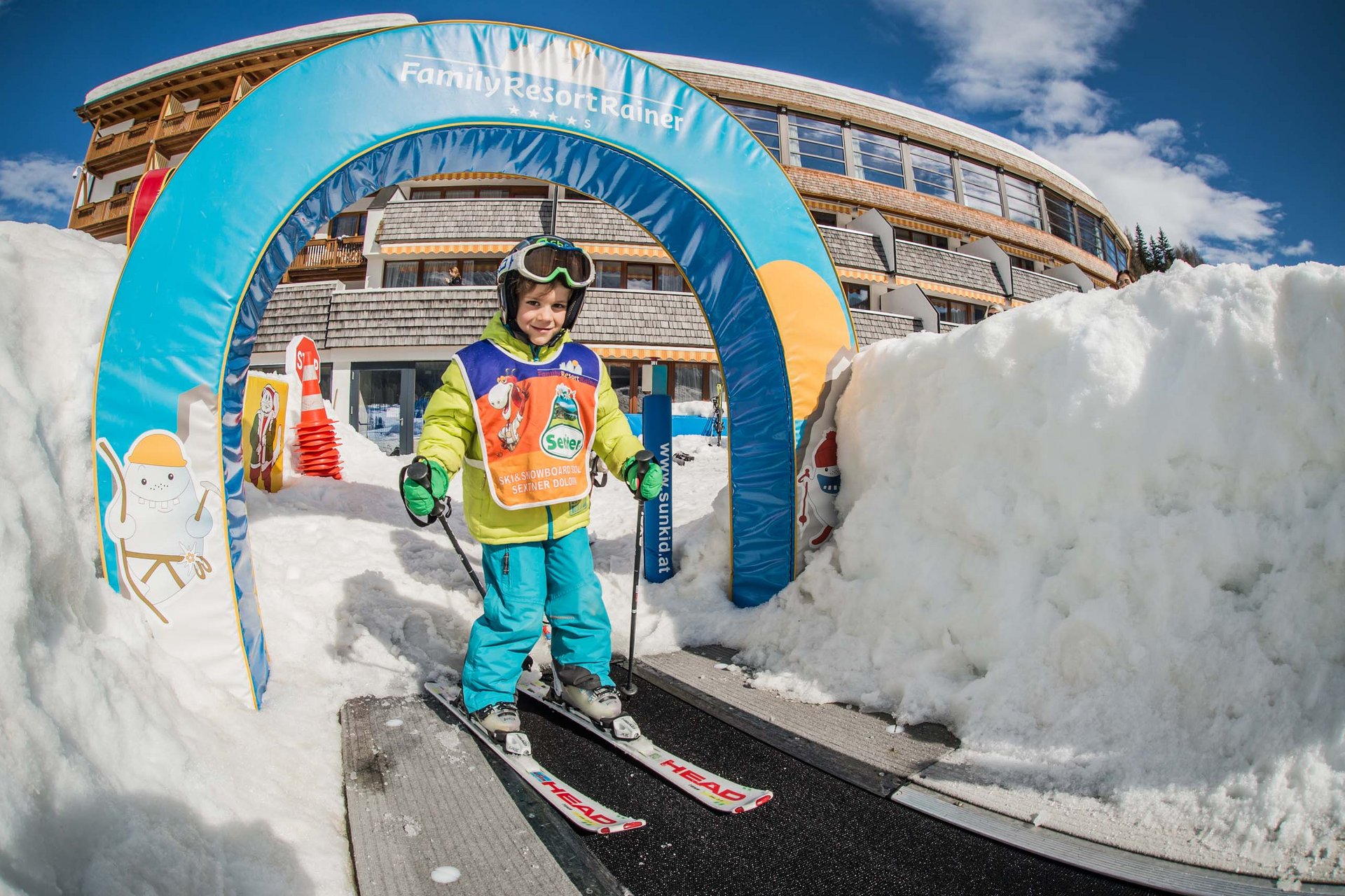 The in-house Rainer Ski School Child learning to ski on conveyor belt at Family Resort Rainer
