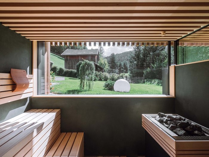 The Residence Königswarte Strata Modern sauna with wooden bench and large window overlooking green landscape