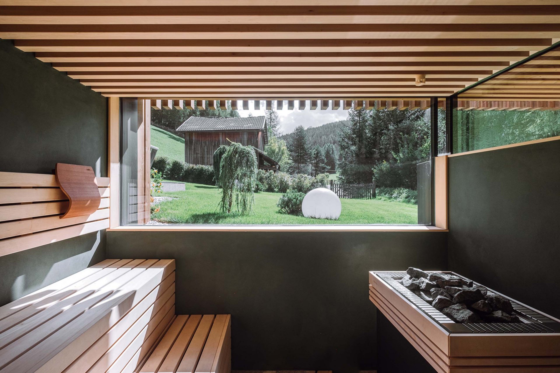 The Residence Königswarte Strata Modern sauna with wooden bench and large window overlooking green landscape