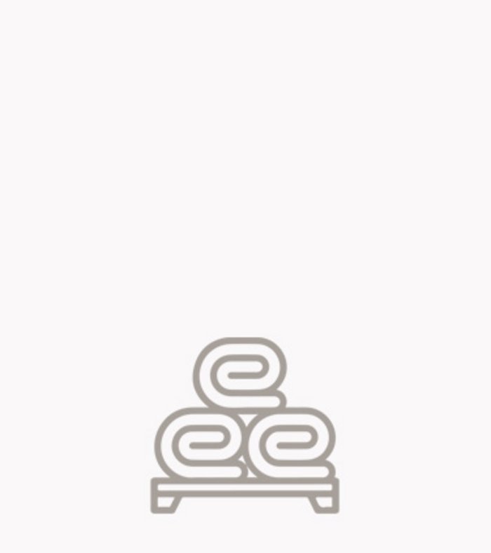 Sustainability at the Family Resort Rainer Three rolled towels on a shelf